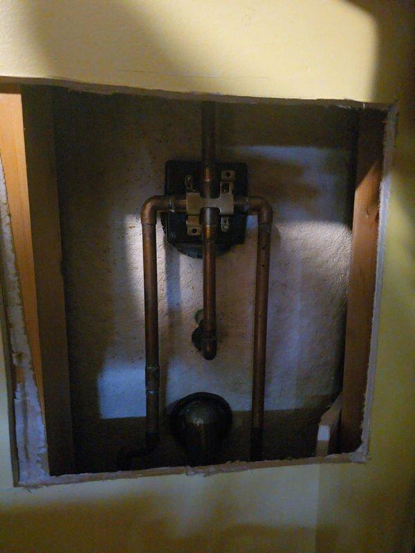 Installed customer-supplied trim kit for bathroom shower and tub fixture, including bronze finish control valve with square escutcheon plate and matching tub spout with diverter mechanism. Verified proper operation of temperature control and water flow through both shower and tub outlets, with all components functioning correctly upon completion.