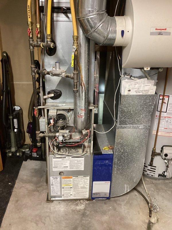 Completed Family Rewards annual cooling maintenance visit on residential air conditioning system. Performed comprehensive tune-up including inspection of outdoor unit electrical components, capacitor, contactor, and wiring connections; all components found operational with normal age-related weathering noted. Indoor furnace and HVAC system inspected with gas connections, ductwork, and filtration systems verified in proper working order.