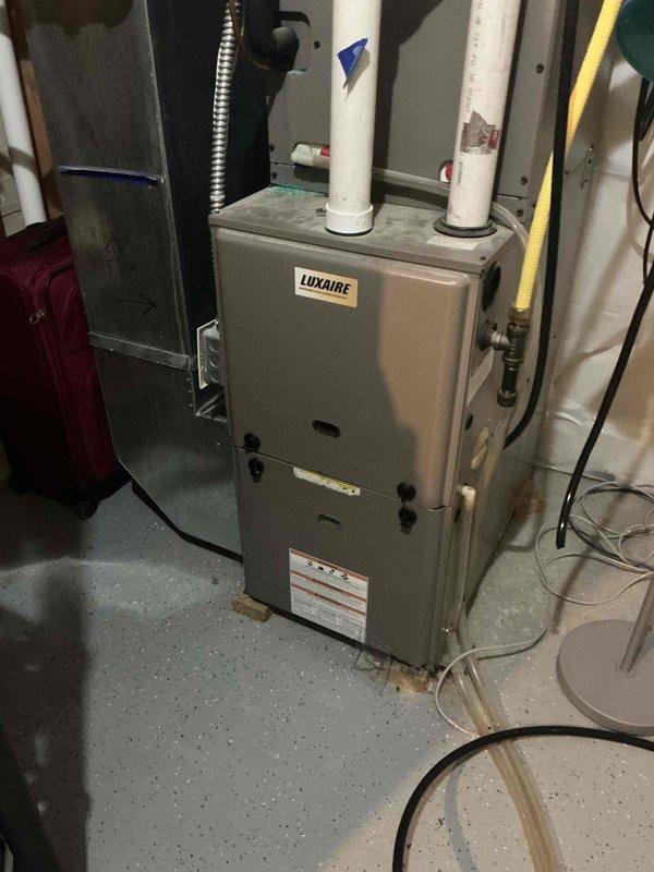 Responded to no cooling complaint on 17-year-old Luxaire air conditioning system. Diagnosed failed capacitor and dirty condenser coil as cause of warm air discharge. Replaced defective capacitor and cleaned condenser coil. Verified contactor operation, refrigerant charge levels, and air filter condition—all within normal parameters. Confirmed system restoration with 18-degree temperature split across evaporator coil. Provided homeowner instruction on proper condenser coil maintenance procedures. System operating to manufacturer specifications upon departure.