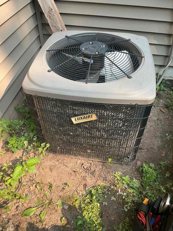 Responded to no cooling complaint on 17-year-old Luxaire air conditioning system. Diagnosed failed capacitor and dirty condenser coil as cause of warm air discharge. Replaced defective capacitor and cleaned condenser coil. Verified contactor operation, refrigerant charge levels, and air filter condition—all within normal parameters. Confirmed system restoration with 18-degree temperature split across evaporator coil. Provided homeowner instruction on proper condenser coil maintenance procedures. System operating to manufacturer specifications upon departure.