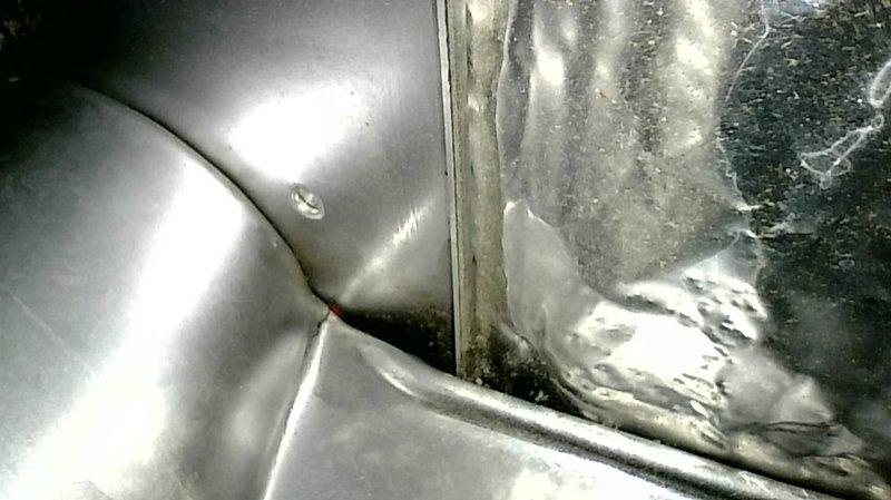 Responded to no-cool complaint on 27-year-old R-22 split system. Performed diagnostic testing at 80°F outdoor ambient temperature, measuring liquid line pressure at 135 psig and suction pressure at 21 psig. System equalized to only 49 psig when shut down, indicating critically low refrigerant charge and probable significant refrigerant loss. Operating pressures confirmed system is severely undercharged and not functioning within acceptable parameters.

During comprehensive system inspection, performed furnace evaluation and discovered cracked heat exchanger approximately 1–2 inches in length at burner inlet. Conducted visual verification using inspection camera and documented findings with photography. Due to safety hazard posed by compromised heat exchanger, red-tagged furnace and removed unit from service per safety protocols.

Reviewed findings with homeowner using real-time camera inspection to show heat exchanger damage. Explained that both air conditioning system's poor operating