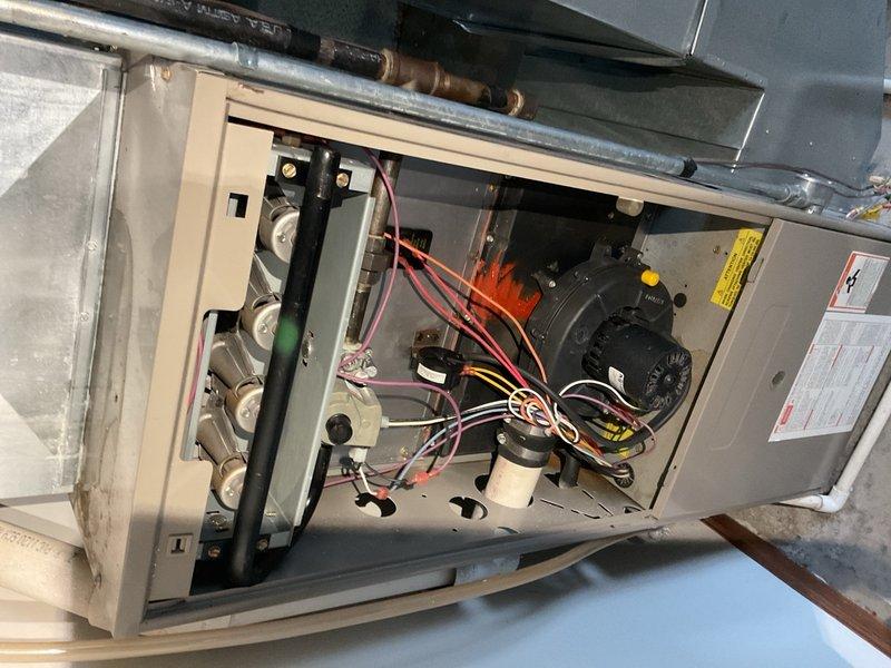 Responded to no-cool complaint on 27-year-old R-22 split system. Performed diagnostic testing at 80°F outdoor ambient temperature, measuring liquid line pressure at 135 psig and suction pressure at 21 psig. System equalized to only 49 psig when shut down, indicating critically low refrigerant charge and probable significant refrigerant loss. Operating pressures confirmed system is severely undercharged and not functioning within acceptable parameters.

During comprehensive system inspection, performed furnace evaluation and discovered cracked heat exchanger approximately 1–2 inches in length at burner inlet. Conducted visual verification using inspection camera and documented findings with photography. Due to safety hazard posed by compromised heat exchanger, red-tagged furnace and removed unit from service per safety protocols.

Reviewed findings with homeowner using real-time camera inspection to show heat exchanger damage. Explained that both air conditioning system's poor operating