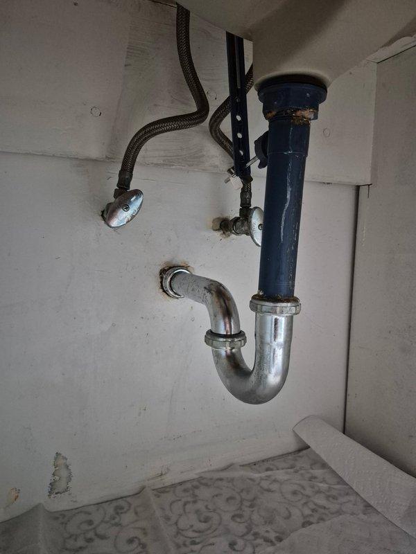 Responded to water leak underneath bathroom sink. Upon inspection, discovered the tubular drain assembly was improperly installed, causing the leak. Removed the incorrectly plumbed P-trap and drain components. Replaced and repiped the complete tubular assembly with proper configuration, ensuring all connections were secure and watertight. Tested the system to verify no leaks were present and proper drainage was restored.