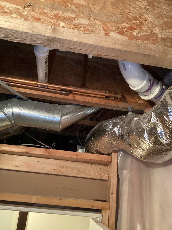 Responded to service call for basement bathroom exhaust fan reported to be accumulating water. Upon inspection, no active leaking or moisture buildup was observed at time of visit. Examined ductwork routing and connections in ceiling space, verifying proper installation and support of flexible duct system. Customer indicated issue occurred intermittently on only a few occasions. Recommended use of dehumidifier to manage basement moisture levels and advised monitoring for future occurrences.