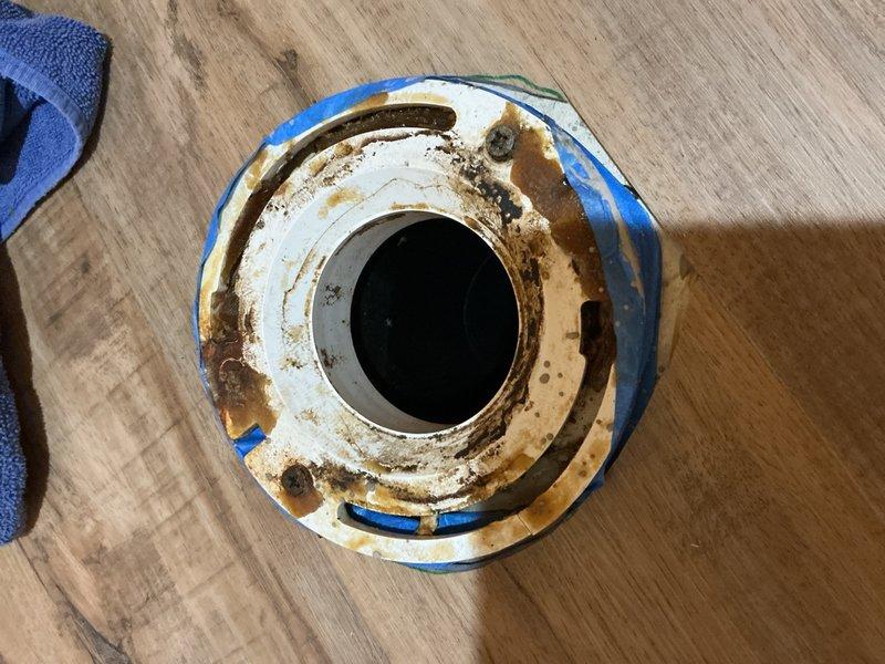 Responded to toilet repair at location 12-5 where inspection revealed a cracked toilet flange. Removed the existing corroded and deteriorated closet collar, which exhibited significant rust damage and structural compromise. Installed a new closet collar to restore proper toilet mounting and ensure a secure, leak-free seal for the fixture.