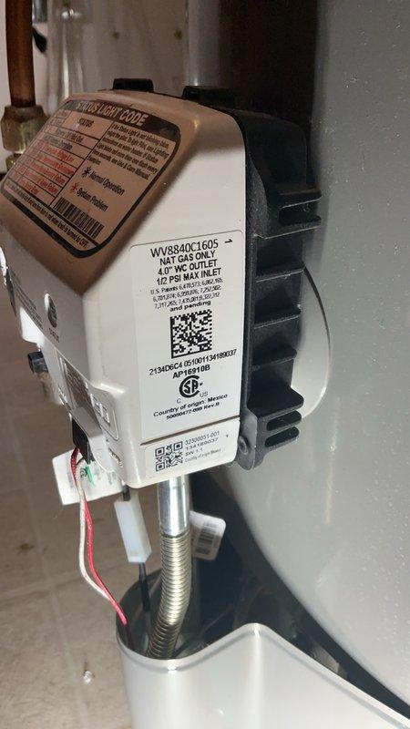 Responded to a no-hot-water call and diagnosed a failed gas valve on a tanked water heater where the status box was damaged, preventing pilot light operation and status light activation. A component of the gas valve assembly had broken off, rendering it inoperable. Replaced the gas valve with a new unit outside of warranty per customer preference to expedite restoration of service, completed installation, tested system operation, and restored hot water functionality.