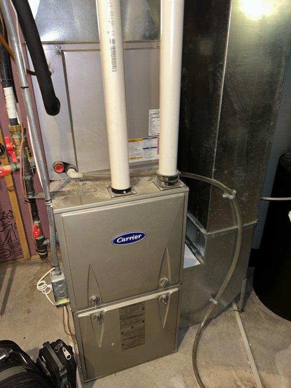 Performed comprehensive furnace tune-up and heating system inspection on Carrier unit as part of Family Rewards maintenance program. Verified safe carbon monoxide levels, adjusted gas pressure to manufacturer specifications, and confirmed proper blower speed and airflow. Cleaned flame sensor, inspected and cleared pressure switch and drain line with no blockages found, and verified inducer motor operation. All heating sequences completed properly with no condensate leaks or water issues detected, and system is operating within normal parameters.