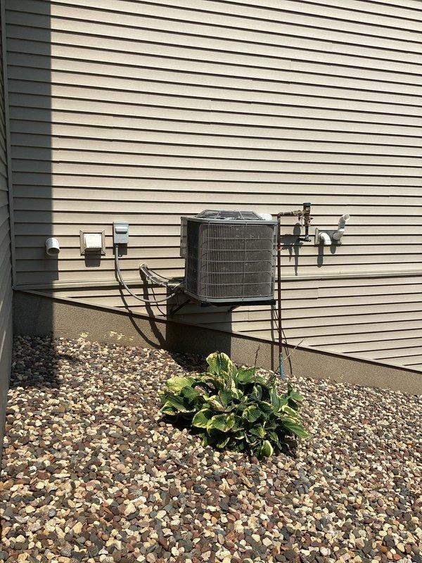 Completed annual cooling maintenance and tune-up on residential air conditioning system under Family Rewards membership agreement. Performed comprehensive inspection of outdoor condensing unit, verified refrigerant lines and electrical connections, and confirmed system operational status with no issues identified. Applied Hurlburt service sticker to unit documenting maintenance completion and 12-month service interval reminder.