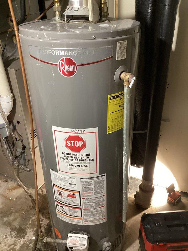 Responded to no hot water complaint affecting entire residence. Upon inspection, discovered 9-year-old water heater with partially melted gas valve, rendering unit unsafe for continued operation. Replaced failed water heater with new Rheem Performance Plus tanked gas water heater. Installed unit in basement utility area with proper copper piping connections, ensuring compliance with manufacturer specifications and safety standards. Verified all connections, tested system operation, and confirmed hot water restoration throughout the home.
