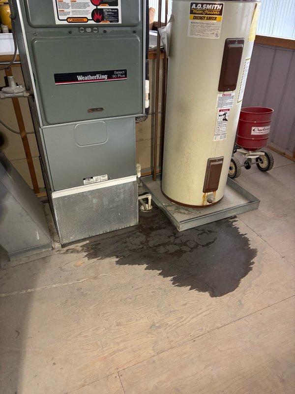 Responded to emergency no-cool call at commercial auto body shop with water leaking through ceiling tiles in main office area. Found approximately 30-year-old RUUD unitary R-22 rooftop system with completely frozen suction line and evaporator coil causing active water damage to ceiling tiles and flooring. Initial diagnostic readings at 93°F outdoor ambient showed abnormal 120 psig on both suction and liquid lines. Inspection revealed condenser coil heavily plugged with grass clippings and debris, severely restricting heat rejection, along with dirty 20x20x1 filter that had not been serviced in approximately three months, causing critical airflow restriction. 

Performed thorough condenser coil cleaning to remove debris buildup and replaced dirty air filter. Allowed frozen coil to thaw completely before restart. Upon system restart, monitored performance and recorded only 12-13°F temperature split after 15-minute runtime, confirming significant underperformance typical of aged equipment