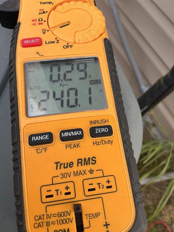 Responded to no cooling complaint on 22-year-old central air conditioning system. Upon arrival, confirmed outdoor condenser fan motor was experiencing delayed start and running at reduced speed, with unit blowing room temperature air through vents. Diagnostic testing revealed failed dual run capacitor on fan circuit, verified through multimeter readings showing capacitance outside acceptable range. Replaced defective dual run capacitor and confirmed proper amperage draw and voltage supply to compressor and condenser fan motor. System previously diagnosed as low on R410A refrigerant charge during earlier service visit. Restored system to operational status with condenser fan motor starting immediately and running at proper speed.