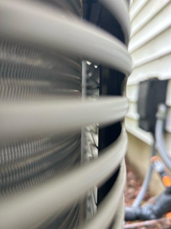 Responded to no-cool call on 5-year-old air conditioning system. Upon arrival, found unit was cooling but experiencing water leakage from evaporator coil drain line. Diagnosed plugged condensate drain causing water backup and overflow onto floor. Cleared blockage from drain line and restored proper drainage flow.

Performed comprehensive system inspection of indoor air handler. Evaporator coil condition satisfactory with no signs of freezing or damage. Air filter clean and within acceptable service parameters. Checked all accessible ductwork connections for proper sealing.

Inspected outdoor condensing unit and found coil heavily contaminated with dirt and debris restricting airflow. Removed access panels and performed thorough cleaning of condenser coil fins to restore heat transfer efficiency. Cleaned exterior cabinet and surrounding area of accumulated debris.

Conducted electrical system diagnostics. Tested capacitor for proper microfarad rating and verified within manufacturer spe