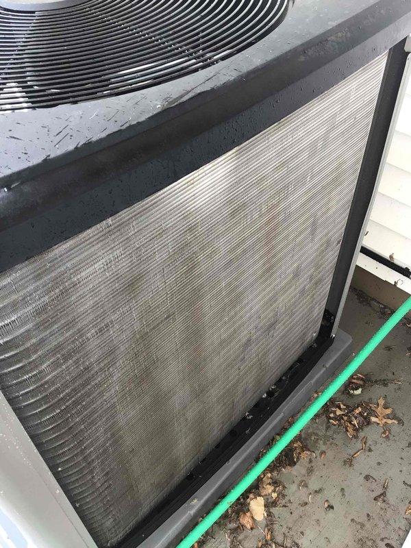Completed comprehensive AC tune-up on outdoor condensing unit. Thoroughly washed exterior coils to remove heavy accumulation of dirt, debris, and biological growth that had built up on condenser fins and cabinet panels. Performed complete electrical inspection and verified all connections secure and within specifications. Unit operating properly with normal cooling performance; customer had recently replaced air filter prior to service visit.