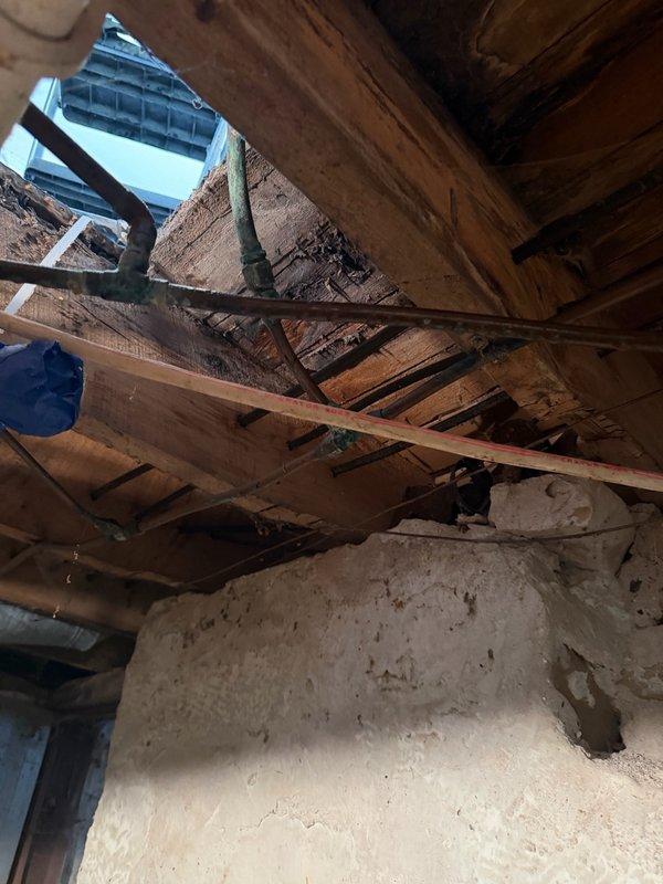 Responded to remodeling project requiring water line modifications. Provided estimate for capping off 3/8" copper water lines in basement that were feeding an unused bathroom, capping supply line to secondary kitchen, and reinstalling toilet after plumbing work completion. Assessed existing plumbing configuration through exposed floor joists and framing to identify proper shut-off and capping locations for discontinued water supply lines.