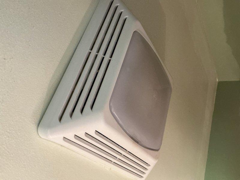 Responded to humidity concern showing 60% on thermostat. Upon arrival, verified actual humidity reading at 55% and found thermostat humidity control incorrectly set to dehumidifier mode despite no dehumidifier unit being present. Corrected thermostat settings by switching humidity control to off position, advised optimal indoor humidity range of 40-50%. Inspected existing bathroom exhaust fan with integrated lighting, which was reported as old and not functioning properly. Documented current fan condition with photos and notified dispatch that customer requested estimate for high-volume bathroom exhaust fan replacement to be sent via email.