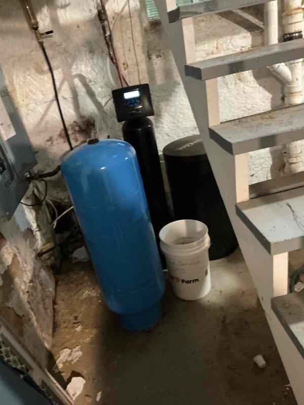 Responded to standing water issue around furnace base in basement. Upon inspection, discovered condensate pump running continuously but failing to discharge water due to clogged backflow preventer blocking water flow. Disassembled condensate pump assembly, thoroughly cleaned all components including backflow preventer, and reassembled system. Tested operation by adding water to condensate pump reservoir and verified proper pumping function and drainage to discharge point. System now operating correctly with no water accumulation.