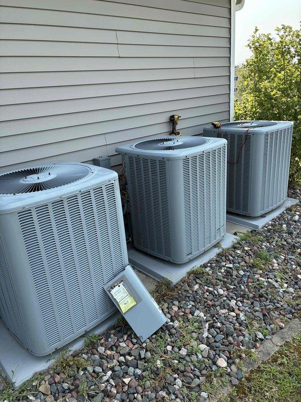 Performed preventive maintenance on four 8-year-old ground-mounted air conditioning systems. Disassembled and thoroughly cleaned all four condensers. Verified all dual-run capacitors (45/5 MFD) were operating within acceptable tolerance range of +/- 5%. Inspected all contactors for proper low voltage amperage and physical condition—all within manufacturer specifications. Measured temperature differentials across all four units, confirming 17-19 degree splits indicating proper refrigerant charge and airflow. Flushed all condensate drain pans to ensure proper drainage. Inspected air filters throughout system; replaced one severely restricted filter and recommended replacement of remaining filters per maintenance schedule. All four systems operating properly with no deficiencies noted at time of service.