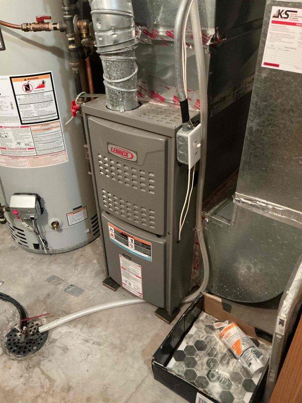Responded to no cooling complaint on 2-year-old Lennox system and found complete freeze-up extending from evaporator coil to compressor. Upon inspection, discovered severely clogged air filter restricting airflow, which homeowner had recently replaced in attempt to resolve issue. Unable to complete full diagnostic testing due to ice buildup requiring thaw time, but restricted airflow from clogged filter identified as likely root cause of freeze condition requiring follow-up visit for verification once system defrosts.