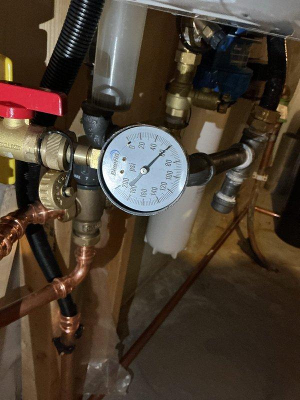 Responded to service call for banging noises in plumbing system associated with tankless water heater operation. Upon inspection, identified severely clogged water filter as primary cause of water hammer and pressure fluctuations. Removed and cleaned filter housing, confirmed hot water system remained operational throughout service. Diagnosed irrigation line routing conflict that was contributing to pressure issues at filter location. Rerouted irrigation line to bypass filter assembly, eliminating interference with main water supply system. Tested all connections for leaks, verified proper water pressure restoration throughout system, and confirmed elimination of banging noises during water heater operation.