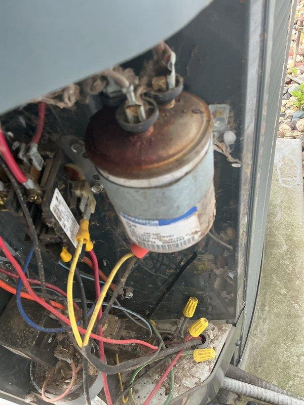 Responded to no cooling complaint on 25-year-old residential HVAC system. Upon inspection, discovered failed dual capacitor with severe corrosion, pitted contactor, condenser fan motor leaking oil, and cracked heat exchanger. Due to safety concerns with the compromised heat exchanger, tagged furnace as unsafe for operation. Replaced dual capacitor, contactor, and condenser fan motor to restore cooling functionality. Heat exchanger replacement required for safe heating operation.