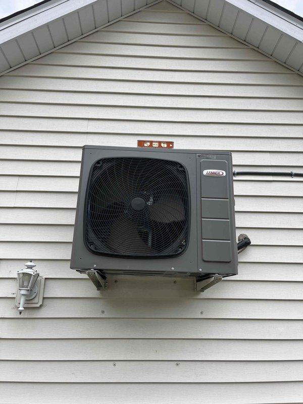 Responded to install callback for wall-mounted Lennox heat pump unit with leveling issues on rear gable wall. Removed homeowner-installed wooden shims that were causing excessive forward tilt. Successfully leveled unit front to back, but left-to-right leveling could not be completed due to 6-foot elevation and single-technician ladder access limitations. Submitted install correction form for crew to return with proper equipment to complete left-to-right leveling adjustment of wall-mounted brackets.