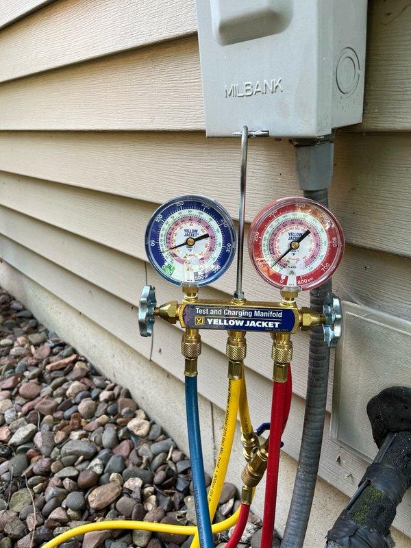 Responded to no cooling complaint with reported hissing noise from basement area. Upon inspection, found condenser fan motor seized, dual run capacitor testing out of specification on hermetic terminal, and contactor showing significant pitting. System pressure testing revealed critically low R22 refrigerant charge, indicating active leak in refrigerant circuit. Explained findings to homeowner including multiple component failures and refrigerant leak requiring repair. Recommended obtaining leak repair estimate and scheduling consultation to review repair options versus system replacement given age of equipment and R22 phase-out considerations.