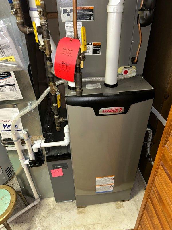 Responded to emergency service call regarding reported burning smell and skin irritation near Lennox furnace system installed one year prior. Conducted comprehensive safety inspection of furnace and evaporator coil with no visual signs of burning or scorching detected. Performed gas leak detection testing on all joints, connections, and PVC venting using calibrated gas detector with negative results confirmed. Verified return and supply air temperatures within normal operating parameters. Discovered air filter installed backwards, corrected orientation and cleaned filter media. Traced odor source to adjacent water heater during heating cycle, confirmed safe operation. System cleared for continued operation with recommendation for annual preventive maintenance service.