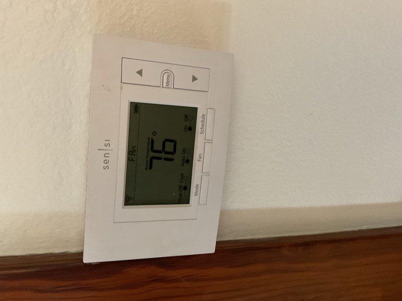 Responded to no-cooling complaint on 2015 ICP R-410A split system. Upon arrival, confirmed outdoor unit fan motor was operating but system produced no cooling. Diagnosed failed dual run capacitor rated at 30/5 µF, testing at 0.1/4.9 µF on compressor terminal and 4.9 µF on fan terminal. Replaced capacitor and verified compressor and condenser fan motor operation restored.

During system operation assessment, identified severe crimp in suction line at point of exit from structure, creating significant refrigerant flow restriction. Performed system performance evaluation with outdoor ambient temperature at 87°F. Recorded suction pressure at 139.1 PSIG with corresponding vapor saturation temperature of 48.5°F. Liquid line pressure measured 317.3 PSIG with condensing saturation temperature of 99.7°F. Liquid line temperature recorded at 99.4°F, yielding subcooling of only 0.3°F versus manufacturer specification of 10°F, indicating severe undercharge or restriction. Indoor temperature split m