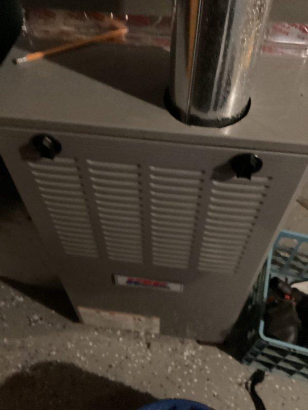 Completed annual cooling maintenance tune-up on residential AC system as part of membership agreement. During inspection, identified fluctuating refrigerant pressures and measured 14-degree temperature split across the evaporator coil, which falls below the optimal 15-20 degree range for efficient cooling operation. Documented findings with diagnostic photos of attic-mounted air handler unit and multimeter readings; advised customer of performance concerns and recommended follow-up with original installing contractor to address refrigerant charge and system efficiency issues.