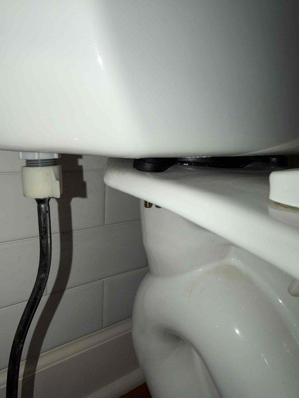 Responded to report of leaking upper-level toilet. Upon investigation, identified the source of the leak as loose tank-to-bowl bolts rather than a failed tank-to-bowl gasket as initially suspected. Tightened the tank-to-bowl mounting bolts to manufacturer specifications, resolving the leak. Documented toilet make and model and confirmed proper seal integrity after adjustment.