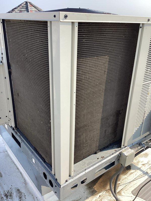 Completed preventive maintenance agreement service on two commercial rooftop units. Replaced return air filters with multiple sizes including 25x20x2, 14x20x2, and 20x20x2 filters. Cleaned condenser coils on both RTUs to ensure optimal heat transfer and system efficiency. Verified proper fan operation and cooling performance on all equipment. Performed comprehensive tune-up procedures and operational checks. Both units operating within normal parameters with no issues reported at time of service completion.