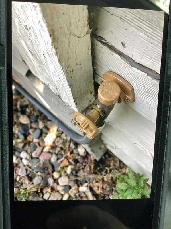 Responded to a water leak at an exterior hose bib that had been previously repaired. Upon inspection, identified that the packing nut had loosened, causing the leak at the valve stem. Tightened the packing nut to proper torque specifications, which resolved the leak and restored full functionality to the outdoor spigot.