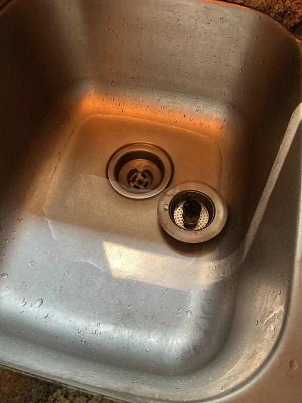 Responded to service call for kitchen drain stoppage and two leaking outdoor hose bibs. Upon diagnostic inspection, confirmed kitchen sink was backing up and required cabling, and both exterior hose spigots exhibited dripping when water was turned on. Cabled kitchen sink drain to full cable length, successfully clearing the blockage and extracting a large amount of debris from the drain line. Reassembled drain components and performed operational testing to verify proper drainage and confirm no leaks were present. Customer declined to proceed with hose bib replacement at this time.