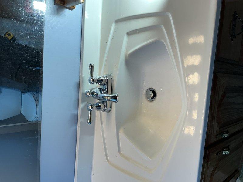 Replaced four P-traps under kitchen and bathroom sinks to facilitate proper cleaning and maintenance access, removing previously glued connections that prevented serviceability. Installed one chrome centerset bathroom faucet with dual lever handles in basement bathroom, completing all connections to ensure proper water flow and drainage. All fixtures tested and verified operational upon completion.