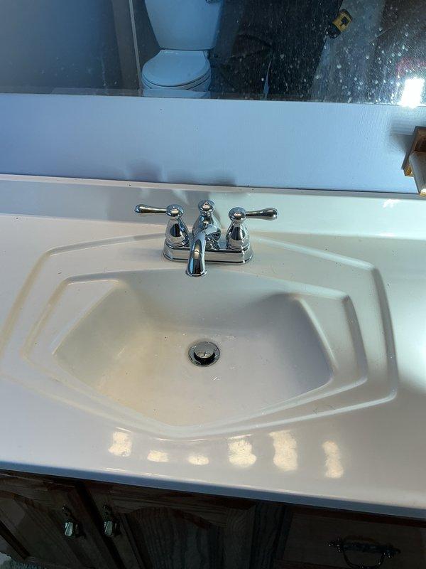 Replaced four P-traps under kitchen and bathroom sinks to facilitate proper cleaning and maintenance access, removing previously glued connections that prevented serviceability. Installed one chrome centerset bathroom faucet with dual lever handles in basement bathroom, completing all connections to ensure proper water flow and drainage. All fixtures tested and verified operational upon completion.