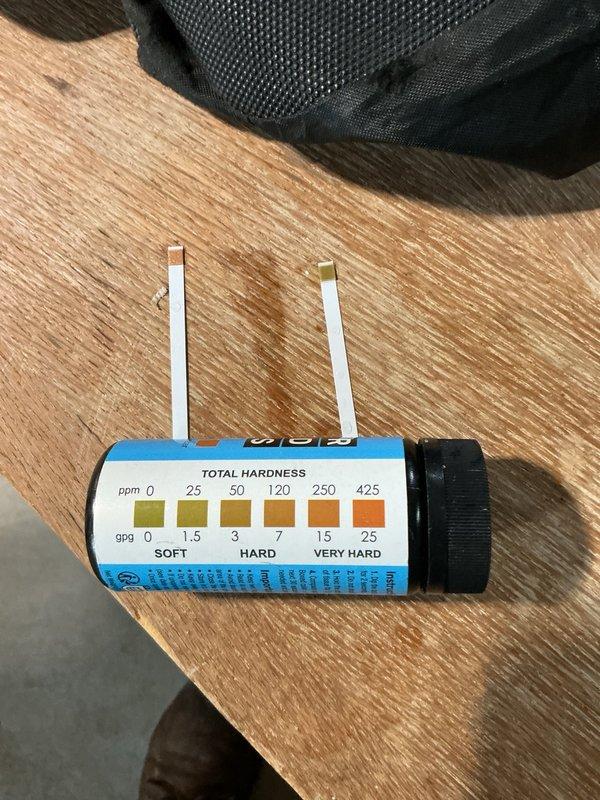 Responded to dispatch for iron staining issues with existing water softener system. Upon inspection, determined that the two-year-old water softener was not adequately addressing iron contamination in the water supply, resulting in brown staining throughout the home. Conducted water hardness testing and documented existing North Star water softener installation. Identified that current system configuration only includes water softening capability and lacks dedicated iron filtration equipment necessary to resolve the staining issue. Recommended installation of iron removal tower to work in conjunction with existing softener system. Submitted request for comprehensive water testing to determine iron levels and appropriate treatment specifications for proper system design.