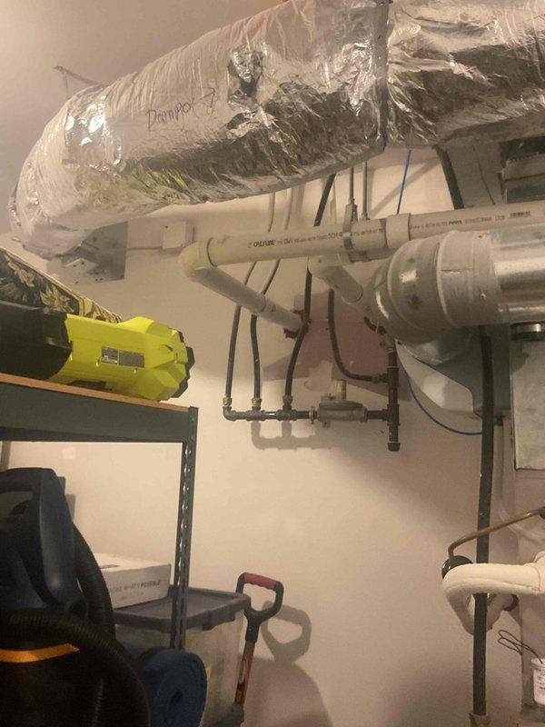 Responded to service call for 6-year-old Bryant furnace experiencing intermittent shutdowns during cold weather with blinking diagnostic light and water accumulation in condensate pan. Upon inspection, homeowner reported water leaking into blower assembly during winter operation and requested camera inspection of PVC condensate drain system to identify potential blockages or improper pitch in piping. Performed visual inspection of furnace unit and traced accessible portions of condensate drain lines in apartment building installation. Documented current system configuration with photographs including furnace cabinet, condensate drain piping with trap, and exhaust venting routing. Determined that comprehensive camera inspection of drain system was necessary but could not be completed during this visit due to extended pipe runs throughout multi-unit building structure requiring specialized equipment. Coordinated with management to obtain building layout and piping schematics to plan foll