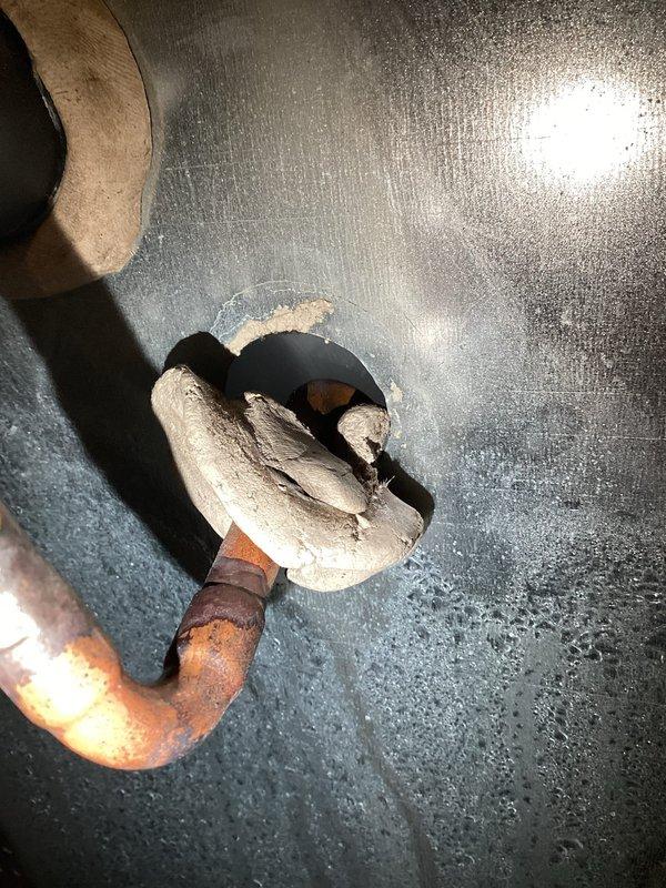 # HVAC Service Report - No Cooling Issue

Responded to no cooling complaint on 10-year-old residential HVAC system. Upon arrival, confirmed unit was not maintaining temperature below 76°F. Observed excessive condensation forming on exterior of equipment and identified frozen evaporator coil.

Performed system diagnostics and discovered critically low refrigerant charge. Cross-referenced service history which indicated low refrigerant readings documented during previous visit, confirming ongoing leak in system. Visual inspection revealed significant corrosion and rust deterioration on copper refrigerant lines, particularly at connection points and exposed sections. Corroded piping showed evidence of prolonged moisture exposure and age-related degradation.

Given the combination of recurring refrigerant loss, advanced corrosion on refrigerant lines, age of equipment, and previous repair attempts, determined system had reached end of serviceable life. Discussed repair versus replacement o