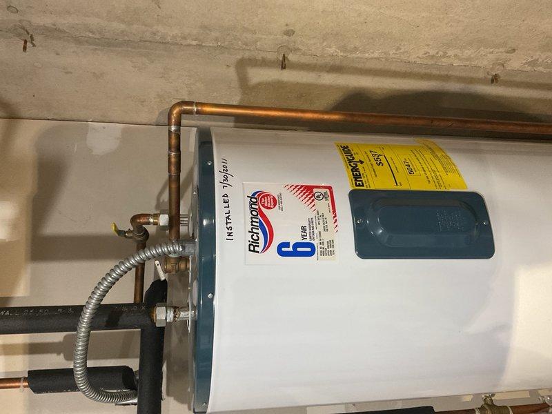 Performed routine cooling maintenance on original 1998 Lennox air conditioning system. Condenser coil was heavily plugged with debris and required thorough cleaning with soap and water to restore proper airflow. All electrical components tested within manufacturer specifications, and system is achieving proper 20-degree temperature split across the evaporator coil. However, inspection revealed evaporator drain pan is actively leaking, with water dripping into the heat exchanger compartment and onto the blower housing, which poses risk of secondary damage to furnace components. Additionally, exterior suction line insulation is severely deteriorated and nearly completely shredded, requiring replacement to prevent efficiency loss and condensation issues. Advised customer that due to age of equipment and developing issues, system replacement should be planned in the near future.