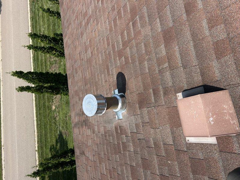 Returned for callback regarding water intrusion into furnace vent stack during heavy rain events. Initial visit identified potential roof flashing issue, but roofing contractor found no deficiencies and replaced roof cap. Upon reinspection, visually confirmed proper installation of new rain cap and flashing boot assembly at vent penetration. Verified all roofing components appear secure and properly sealed. 

Investigated alternative sources of moisture intrusion. Checked refrigerant charge on HVAC system and confirmed levels within acceptable range. Noted system is aged with no legible data plate, making manufacturer identification and specifications unavailable. Given persistent leak issue despite roof repairs and advanced age of equipment with limited serviceability, recommended system replacement evaluation. Coordinated with sales team to provide equipment replacement options. Documented roof penetration and vent cap installation with photos for record.