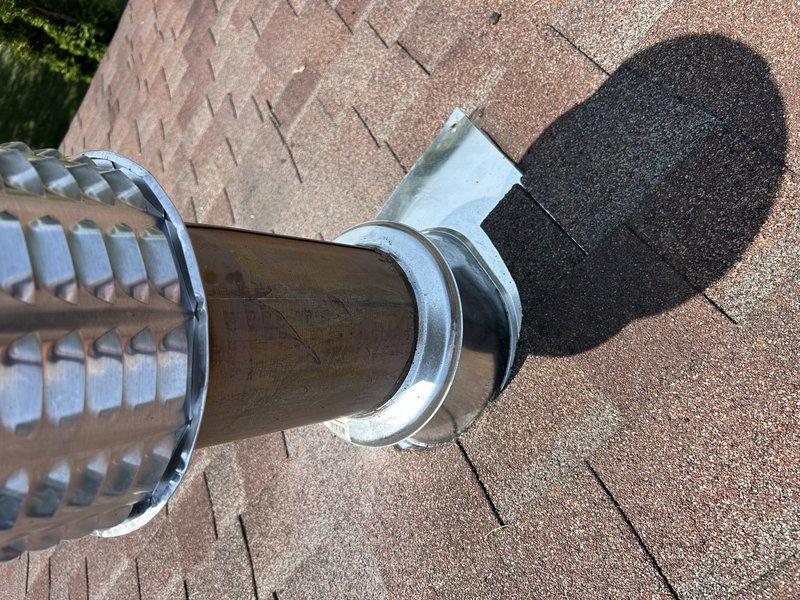 Returned for callback regarding water intrusion into furnace vent stack during heavy rain events. Initial visit identified potential roof flashing issue, but roofing contractor found no deficiencies and replaced roof cap. Upon reinspection, visually confirmed proper installation of new rain cap and flashing boot assembly at vent penetration. Verified all roofing components appear secure and properly sealed. 

Investigated alternative sources of moisture intrusion. Checked refrigerant charge on HVAC system and confirmed levels within acceptable range. Noted system is aged with no legible data plate, making manufacturer identification and specifications unavailable. Given persistent leak issue despite roof repairs and advanced age of equipment with limited serviceability, recommended system replacement evaluation. Coordinated with sales team to provide equipment replacement options. Documented roof penetration and vent cap installation with photos for record.