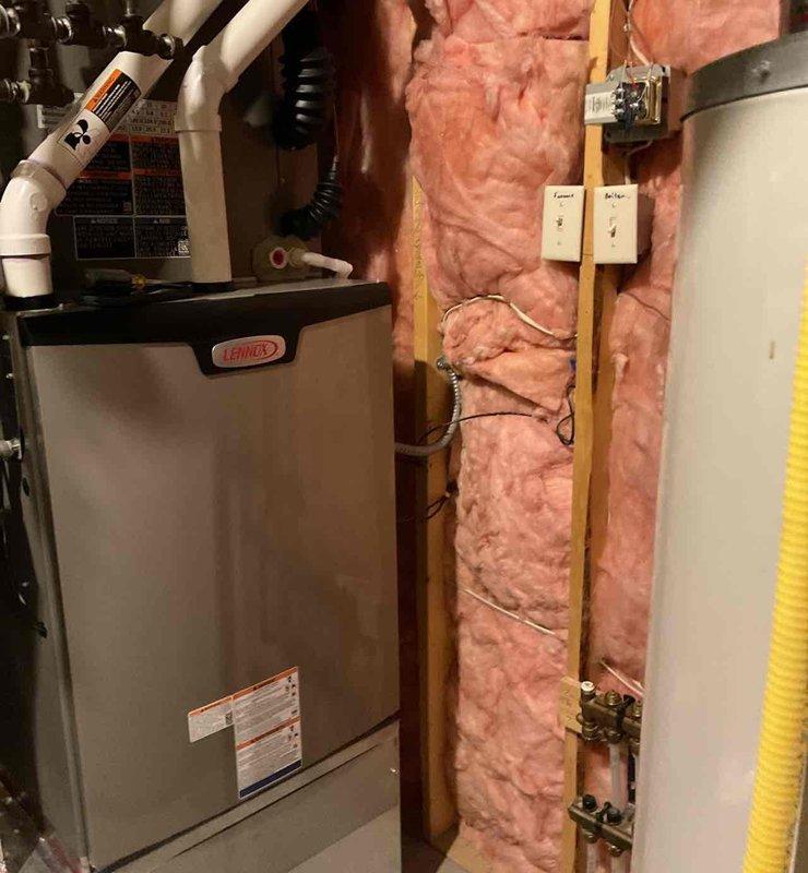 Completed full HVAC system replacement including installation of Lennox EL297V 97% AFUE two-stage multi-speed upflow furnace (135K BTU), EL18KCV 18.0 SEER2 single-stage 5-ton air conditioner, and 5-ton D-frame cased coil with factory-installed TXV valve. Replaced existing thermostat with Lennox S40 programmable unit. Reused existing outdoor disconnect and whip where applicable. During inspection, identified electrical code deficiencies requiring new whip and breaker installation for proper AC connection. Coordinated with electrician to install compliant electrical whip and dedicated breaker to meet current electrical code requirements. Leveled outdoor condenser unit to manufacturer specifications. All equipment installed to code, system tested and operational.