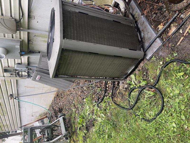 Completed comprehensive maintenance visit for air conditioning and furnace system. Unit was heavily impacted with debris requiring extensive cleaning of condenser coils and exterior components. Evaporator drain pan and coil contained significant buildup; removed, flushed, and thoroughly cleaned. System operational with proper condensation observed; achieved 14° temperature split across evaporator coil. Blower speed maintained at current setting per homeowner satisfaction with cooling performance. All maintenance procedures completed despite inclement weather conditions during service call.