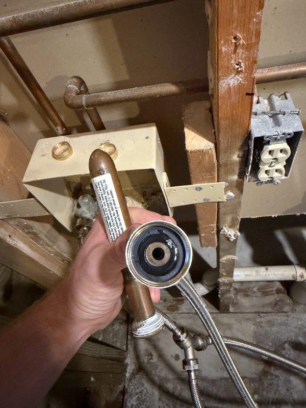 Responded to insurance claim for washing machine water leak. Initial inspection revealed supply line installed without washer, causing massive leak behind unit. Removed both supply lines, installed two new washers, and temporarily capped washing machine valve to allow water restoration company safe access to work area. Return visit completed full reconnection of washing machine with properly installed washers in both supply lines. Tested system under pressure with valve open—no leaks detected. Issue resolved.
