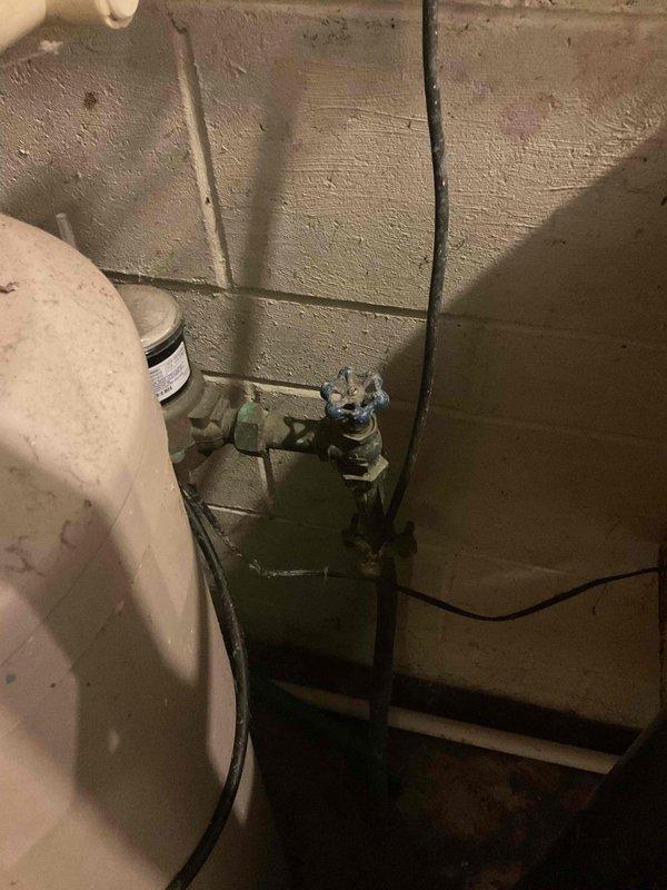 Responded to service call for plumbing issues related to ongoing HVAC installation. Upon inspection, identified a piercing valve requiring removal from the water supply line. Installed a 3/4" press coupling to properly connect the water lines for the HVAC system. During the visit, discovered the main water shut-off valve was non-functional, presenting a significant safety concern for the property. Documented the condition of the failing main shut-off valve with photographs showing corrosion and wear on the green-painted valve assembly mounted to the basement wall. Provided a detailed repair estimate to address the malfunctioning main shut-off valve replacement. Completed the necessary plumbing connections for the HVAC installation at no charge as part of the equipment installation process.