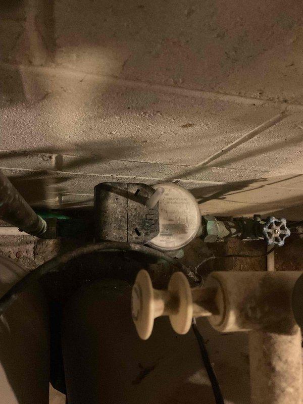 Responded to service call for plumbing issues related to ongoing HVAC installation. Upon inspection, identified a piercing valve requiring removal from the water supply line. Installed a 3/4" press coupling to properly connect the water lines for the HVAC system. During the visit, discovered the main water shut-off valve was non-functional, presenting a significant safety concern for the property. Documented the condition of the failing main shut-off valve with photographs showing corrosion and wear on the green-painted valve assembly mounted to the basement wall. Provided a detailed repair estimate to address the malfunctioning main shut-off valve replacement. Completed the necessary plumbing connections for the HVAC installation at no charge as part of the equipment installation process.