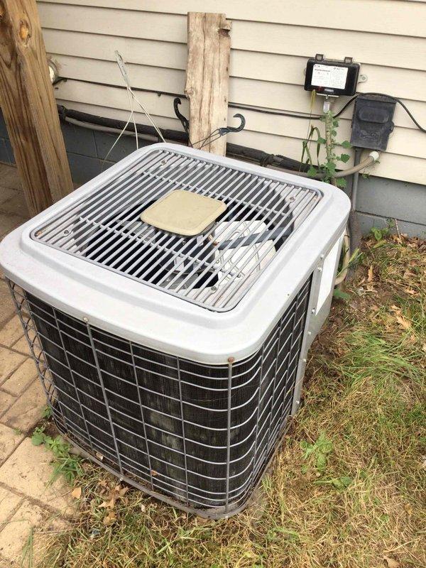 Responded to a no cooling call on a 10+ year old system. Upon arrival, found the outdoor unit fan motor not operating and producing a humming noise. Diagnosed a failed dual run capacitor preventing the condenser fan motor from starting. Replaced the defective capacitor with a new unit rated to manufacturer specifications. Verified proper fan operation, checked amperage draws on both compressor and fan motor, and confirmed system cooling normally. Unit returned to full operational status.