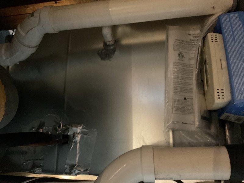 Responded to A/C repair callback on 1996 Goodman air conditioning system. Previous technician had replaced run capacitor, which restored operation temporarily, but unit failed again the same night. Upon arrival, found condenser fan motor locked up. Tested capacitor and confirmed within specification. Checked fan motor windings and measured approximately 100–250 ohms, indicating motor failure. Identified severe crimp in suction line between indoor and outdoor units, which restricts refrigerant flow and contributes to poor system performance. Given the age of the equipment (27 years old) and multiple component failures, recommended system replacement evaluation. Comfort advisor scheduled to provide replacement quote. During inspection, also observed leaking CPVC plumbing requiring attention. Plumbing advisor scheduled for separate quote on piping repairs. Documented conditions with photographs showing corroded plumbing components and mechanical space configuration.