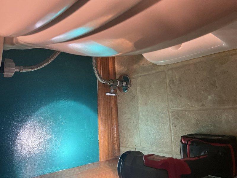 Replaced malfunctioning shut-off valve that was not fully closing water supply to toilet tank. Repositioned new angle stop valve to accommodate installation of American Standard toilet fixture in upstairs bathroom. Relocated existing toilet from upstairs to downstairs bathroom as replacement unit, then installed new American Standard toilet in upstairs location with proper clearance from repositioned shut-off valve.