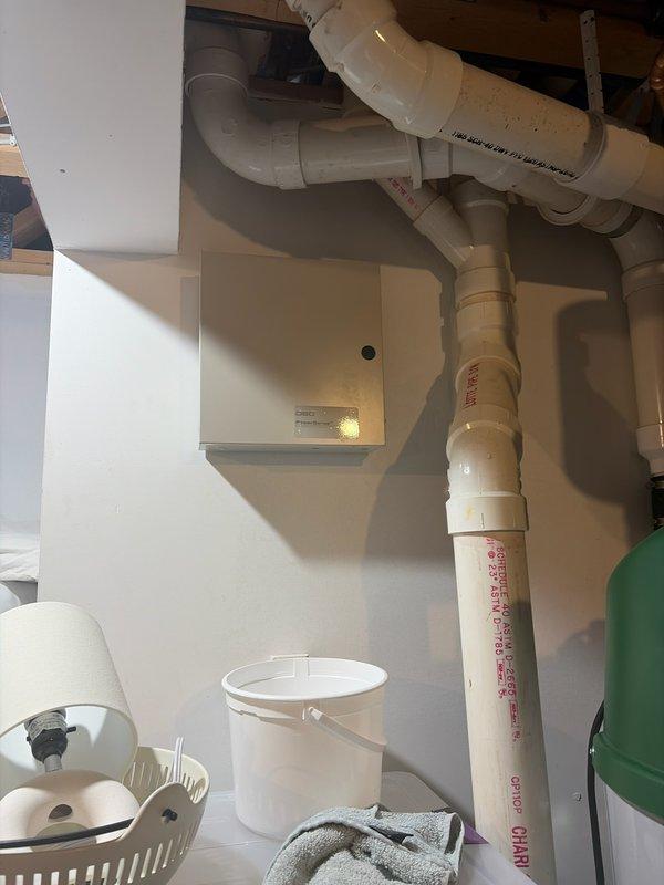 Completed comprehensive plumbing inspection of residential property focusing on reported leaking pipes extending from master bathroom to basement level. Inspected exposed PVC drainage piping system in utility area, examining multiple elbow joints, vertical and horizontal pipe runs, and connection points for signs of leaks or deterioration. Evaluated master bathroom plumbing fixtures including sink, faucet assembly, and associated supply lines for proper operation and potential water intrusion issues.